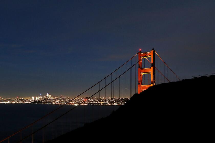 San Francisco, CA - The lights of San Francisco burn bright behind the Golden Gate Bridge on a recent evening. Steeped in history, culture and financial and natural wealth, San Francisco attracts millions of visitors annually. However, the city by the bay now has a dubious reputation for intractable homelessness, rampant crime and an exodus of business. (Luis Sinco / Los Angeles Times)