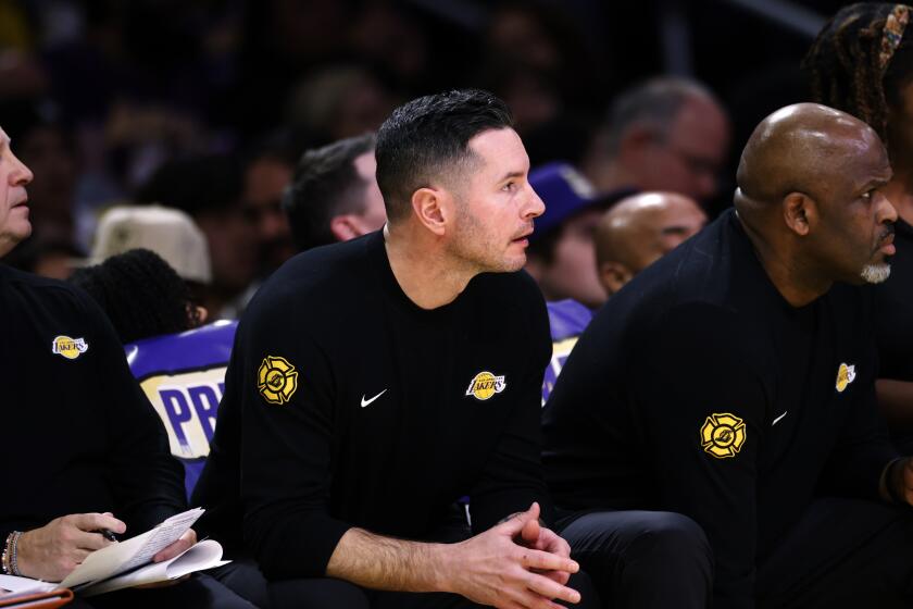 Head coach JJ Redick of the Los Angeles Lakers follows the game from the bench during the second half against Miami Heat during an NBA basketball game Wednesday, Jan. 15, 2025, in Los Angeles. (AP Photo/Kevork Djansezian)